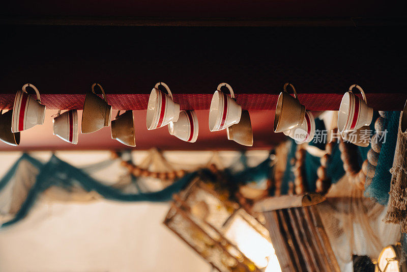 Typical French cider cups hanging in crêperie - Annecy, Haute-Savoie, France